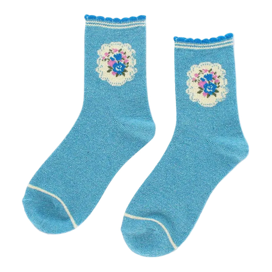 Pair of blue socks with floral designs on a light gray background