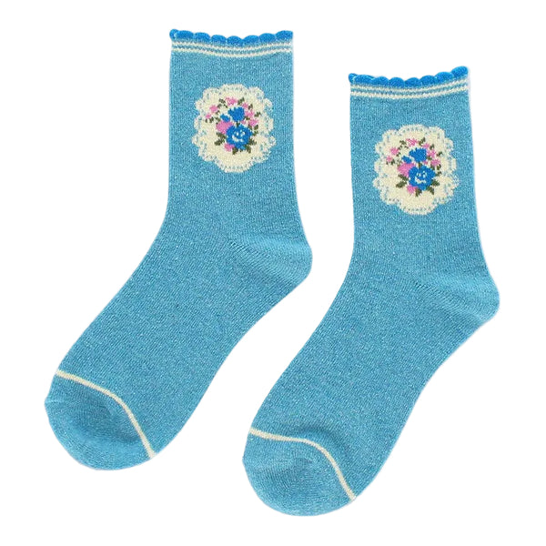 Pair of blue socks with floral designs on a light gray background