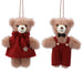 Two teddy bears wearing red outfits with scarves and overalls on a white background