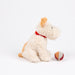 A plush dog toy in cream-colored curly fabric with light tan ears and tail, wearing a bright red collar, sitting next to a small red, white, and tan ball on a clean white background.
