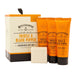 Men's grooming gift set featuring a cream and orange box, three orange tubes of Thistle & Black Pepper aftershave balm, facial wash, and body wash, and a bar of soap on a white background.