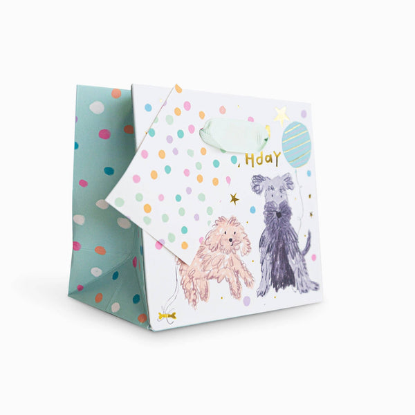Gift bag with dog illustrations and colorful polka dots on a white background