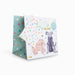 Gift bag with dog illustrations and colorful polka dots on a white background