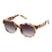 Sunglasses with tortoiseshell frame and gradient lenses on a light gray background