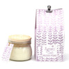 Jar of candle with a matching purple packaging box featuring floral design and 'Agnes + Cat' branding.