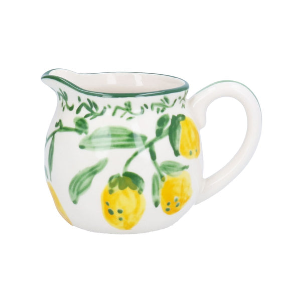 White ceramic creamer with lemon design on a white background