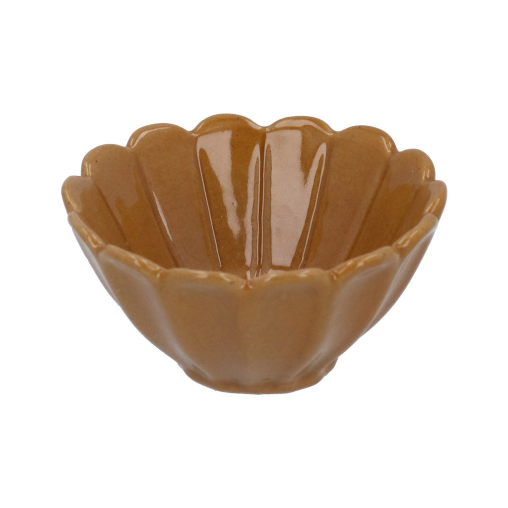 Mustard coloured ceramic bowl with scalloped edge on a white background