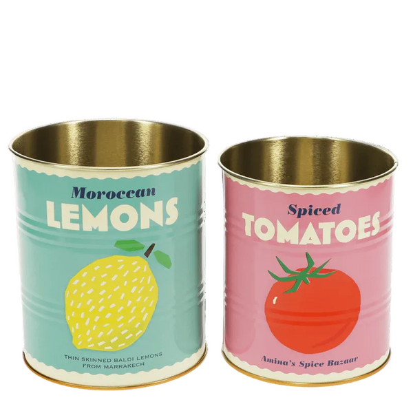 Two tin cans labeled 'Moroccan Lemons' and 'Spiced Tomatoes' on a green background