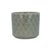 Green ceramic pot with decorative pattern on a white background