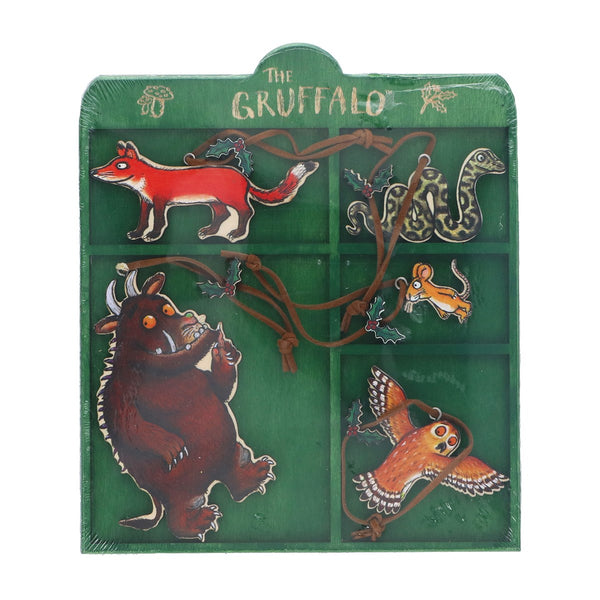 A children's wooden toy puzzle box from 'The Gruffalo' featuring illustrated animal characters on a green background, with brown wooden pegs and cords.