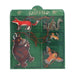 A children's wooden toy puzzle box from 'The Gruffalo' featuring illustrated animal characters on a green background, with brown wooden pegs and cords.