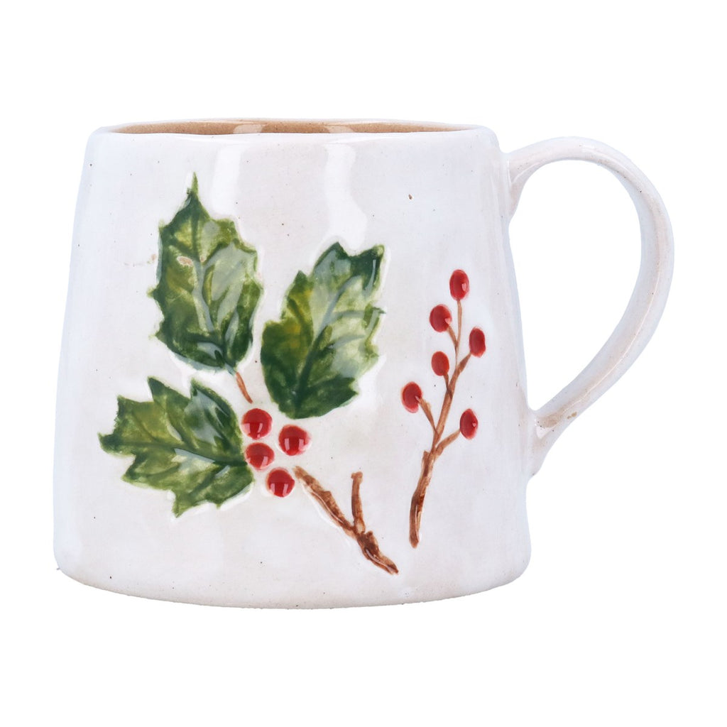 A white ceramic mug decorated with a hand-painted green holly leaf branch and red berries, shown against a plain white background.