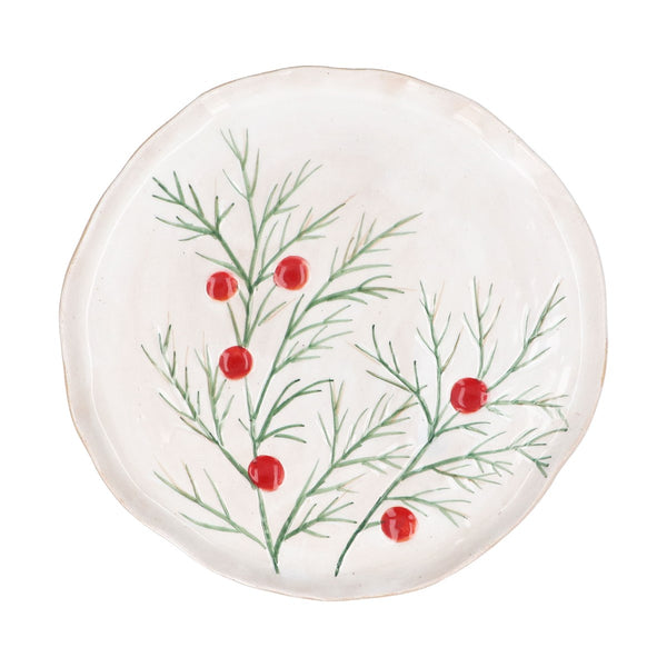 A round white ceramic plate with a hand-painted green holly branch pattern and red berries, shown against a plain white background.
