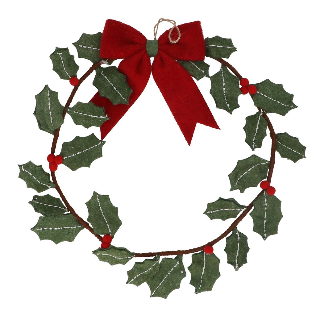 A felt Christmas wreath decoration with green holly leaves, small red berries, and a large red bow at the top, shown on a plain white background.