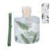 Clear diffuser bottle with green leaf pattern, wooden diffuser sticks, and packaging on a white background