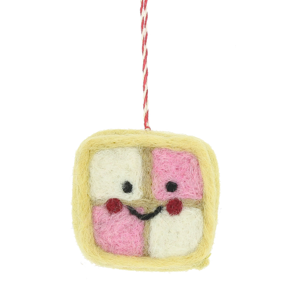 Felted toy resembling a battenburg cake with two faces on a white background