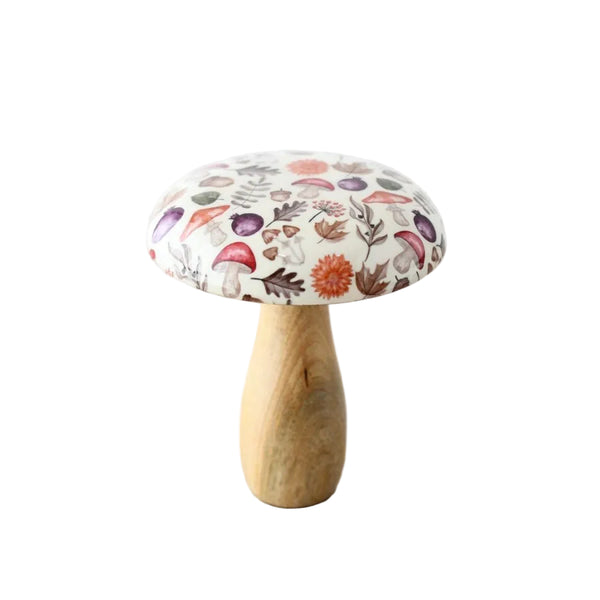 A mushroom-shaped decorative object with a light wood stem and a white fabric cap printed with a multicolor botanical mushroom pattern, standing on a light wood surface against a white background.