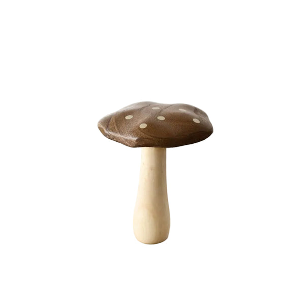 Wooden toy mushroom on a wooden surface with a white background