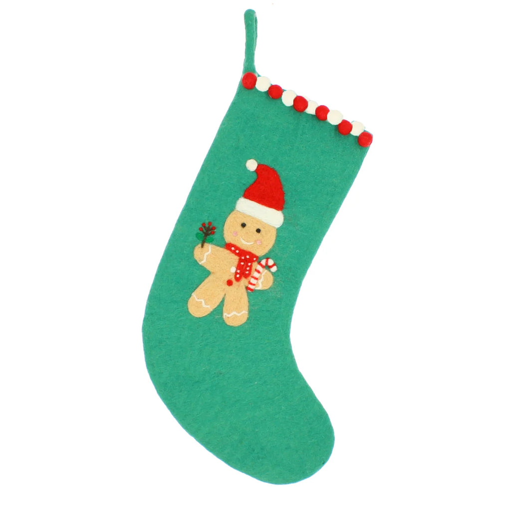 A green felt Christmas stocking with a gingerbread man decoration in the center and red, white, and green pom-pom trim along the top edge, shown against a plain white background.