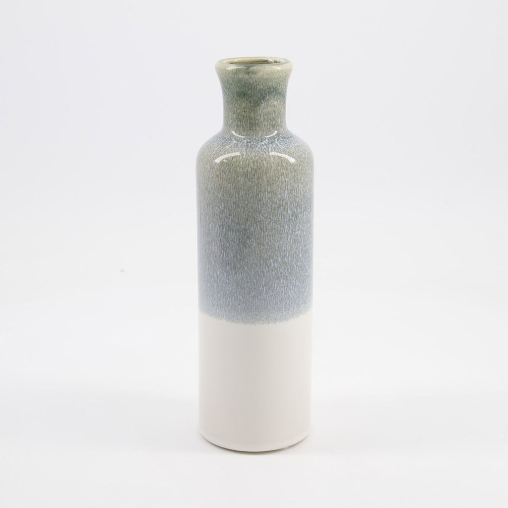 A small ceramic vase with a textured, speckled glaze that transitions from a muted sage green at the top to a soft blue-gray in the middle, and finishes with a smooth, matte off-white base.