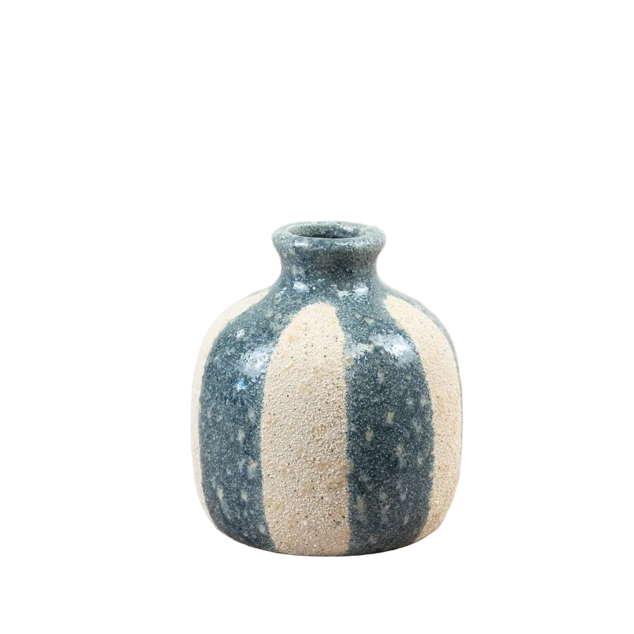 Ceramic vase with two-tone design on a wooden surface