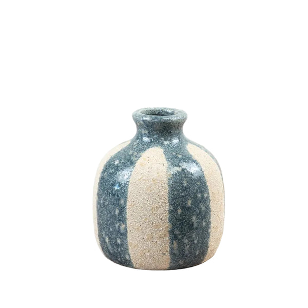 Ceramic vase with two-tone design on a wooden surface