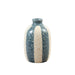 A small handmade ceramic bottle with a dark speckled glaze and a vertical beige stripe, sitting on a light wooden surface against a white background.