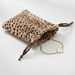 Leopard print drawstring pouch with a gold chain and letter 'A' tag on a white background