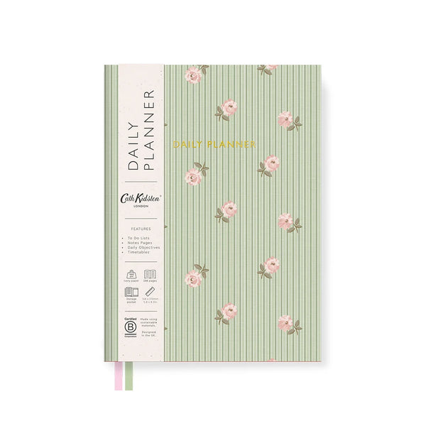 A daily planner notebook with a light green and white vertical striped cover decorated with pink floral motifs. The left spine features a cream-colored band with black text reading 'DAILY PLANNER' and 'Cute Planner London,' along with small feature icons.