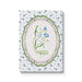 Notebook with floral design on a wooden surface with lavender and eucalyptus leaves.