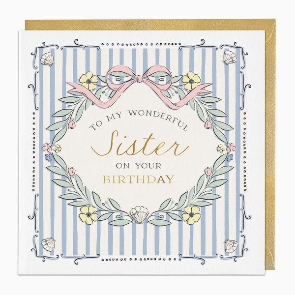 A square birthday card with a gold envelope behind it. The card has a white border, light blue vertical stripes, and a central cream circle with the text 'TO MY WONDERFUL Sister ON YOUR BIRTHDAY' in black and gold script.