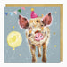 Birthday card with a cartoon pig wearing a party hat and balloons on a blue background