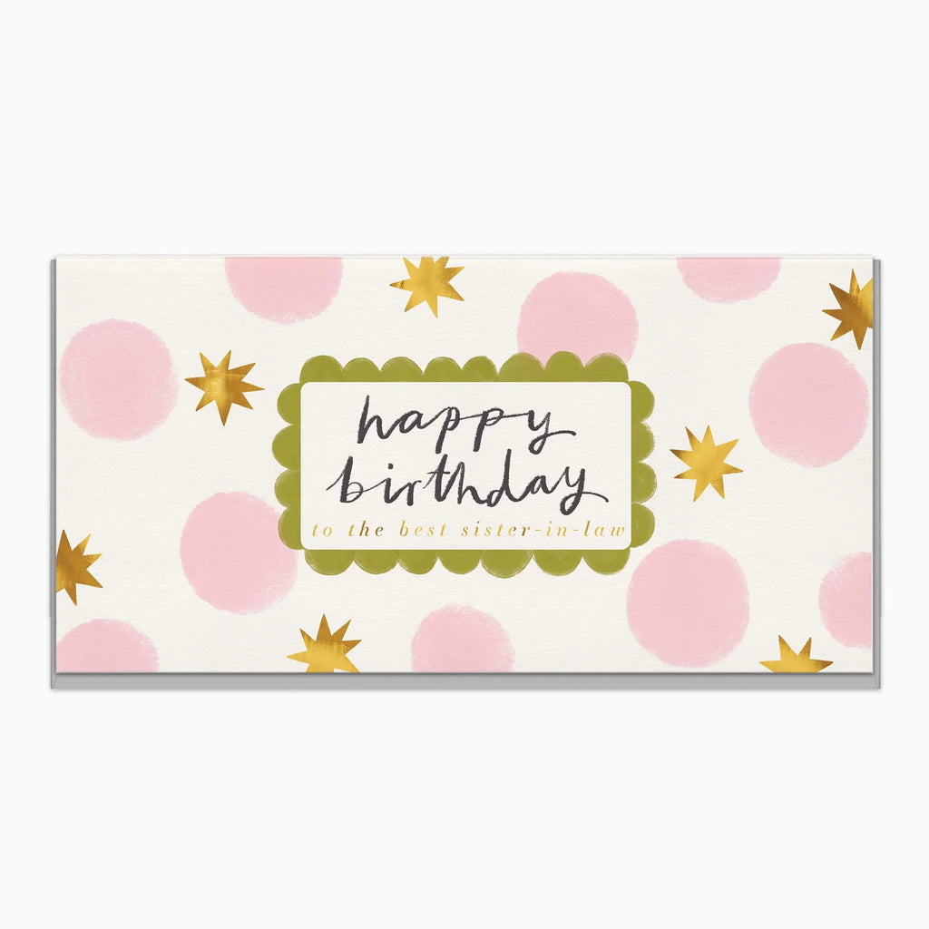 A rectangular greeting card with a white background, pink polka dots, gold starburst accents, and a central scalloped green label reading 'happy birthday to the best sister in law' in black and gold script.