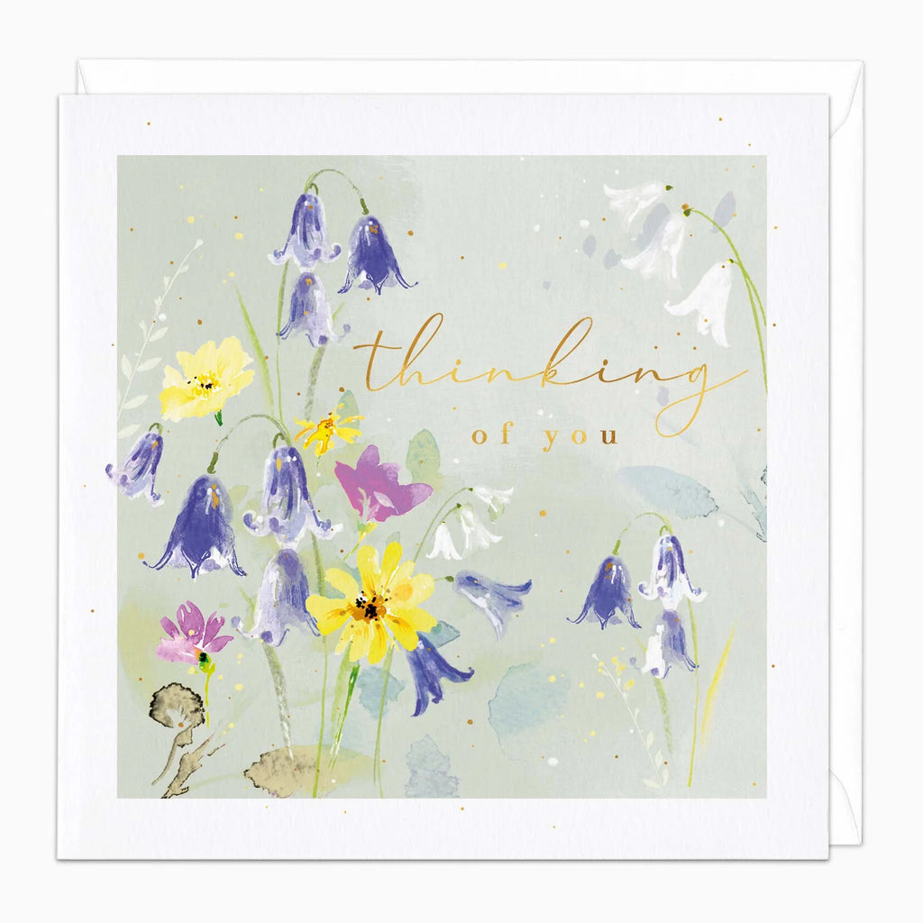 Greeting card with floral design and 'thinking of you' text on a light green background