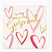 A square greeting card with a white textured background, featuring the phrase 'to my gorgeous Girlfriend' in gold cursive lettering, surrounded by watercolor-style pink and red hearts. A white envelope is partially visible behind the card.