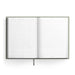 An open hardcover planner or journal with lined pages and printed daily-planning layouts, shown against a clean white background.