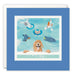 A square greeting card with a blue border and a white envelope behind it. The card features an illustration of several playful dogs swimming in a light blue pool.