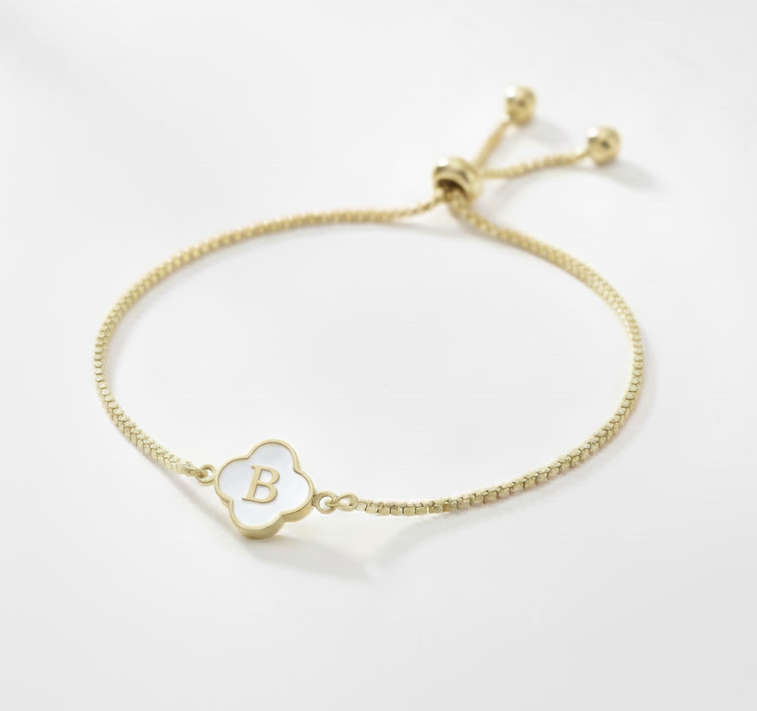 Gold bracelet with a letter 'B' charm on a white background