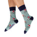 Person wearing socks with bicycle and helmet pattern on a light blue background