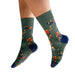 Green socks with sports-themed design worn by a person on a white background