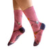 Pink socks with guitar design worn by a person on a white background