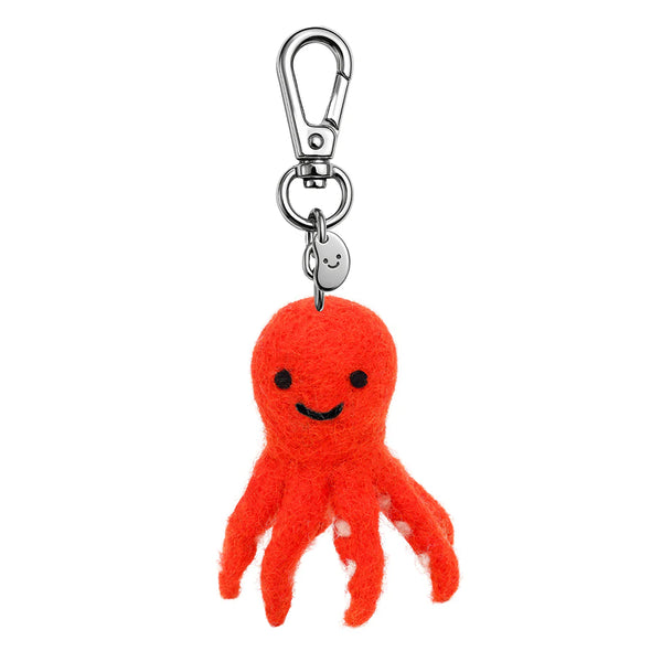 Red octopus keychain with a smiling face on a white background
