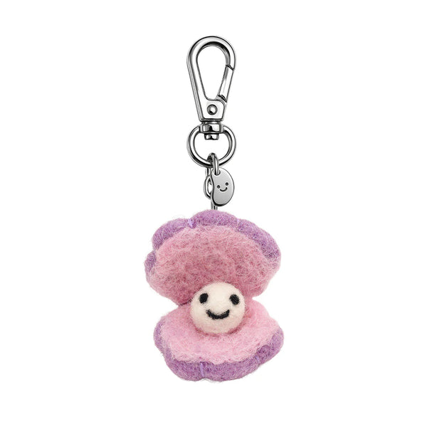 Pink and purple plush clam keychain with a smiling face on a white background
