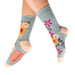 Floral-patterned socks worn by a person on a white background