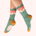 Green socks with fox design worn by a person on a white background