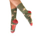 Green socks with sheep pattern worn by a person on a white background