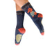 Navy blue socks with a dog design worn by a person on a white background