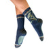 Navy blue socks with floral design worn by a person on a white background