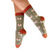 Sock with dog pattern worn by a person on a white background