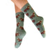 Green socks with bear pattern worn by a person on a white background